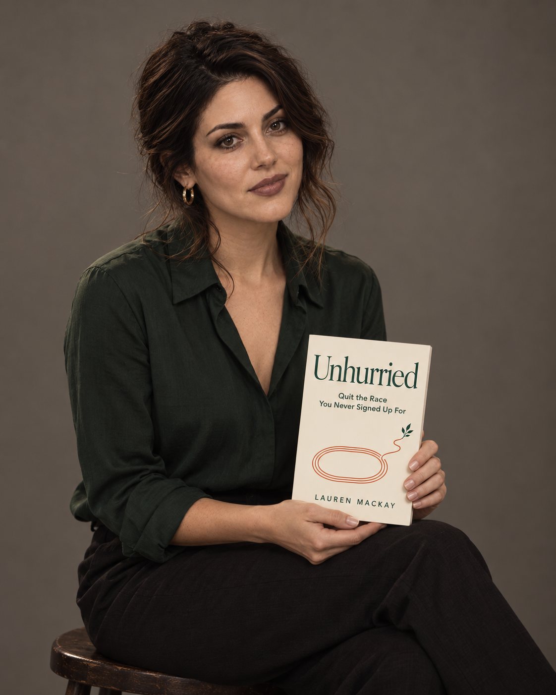 Lauren MacKay holding her book Unhurried